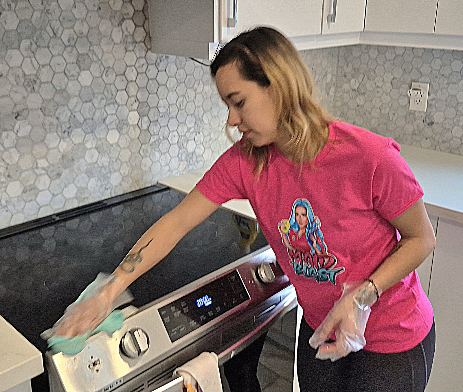cleaner cleaning stove during a house cleaning service.